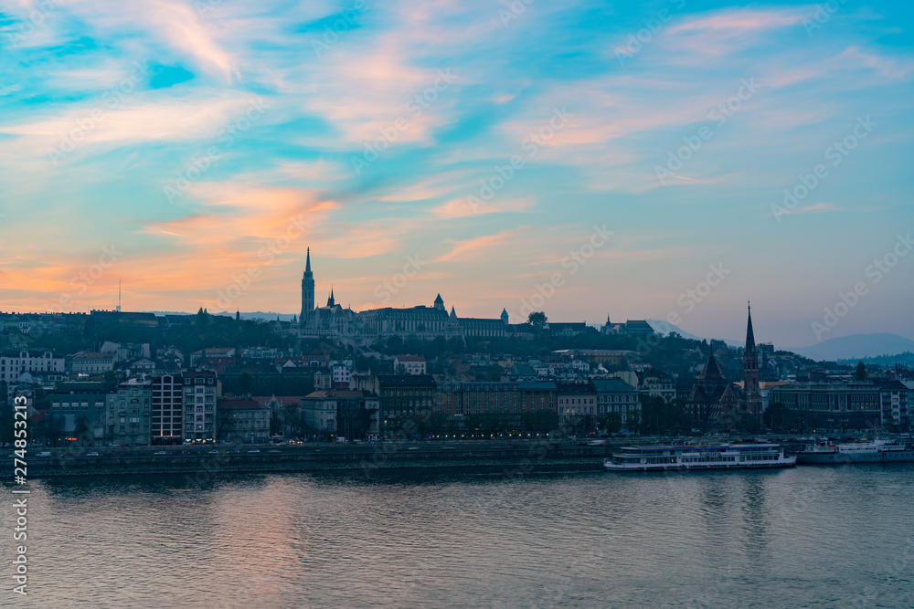 Sunset view of the Matthias Church and River Danube bank