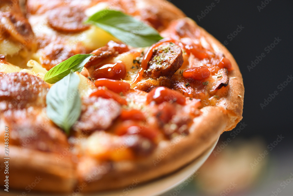 Pizza on tray and ketchup basil leaf close up / delicious tasty fast food italian traditional pizza cheese Pizza on tray and ketchup basil leaf close up / delicious tasty fast food italian traditional pizza cheese