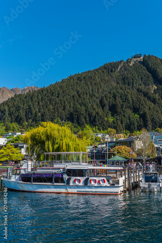 Ship at the pier on lake Wakatipu, Queenstown, New Zealand. Copy space for text. Vertical.