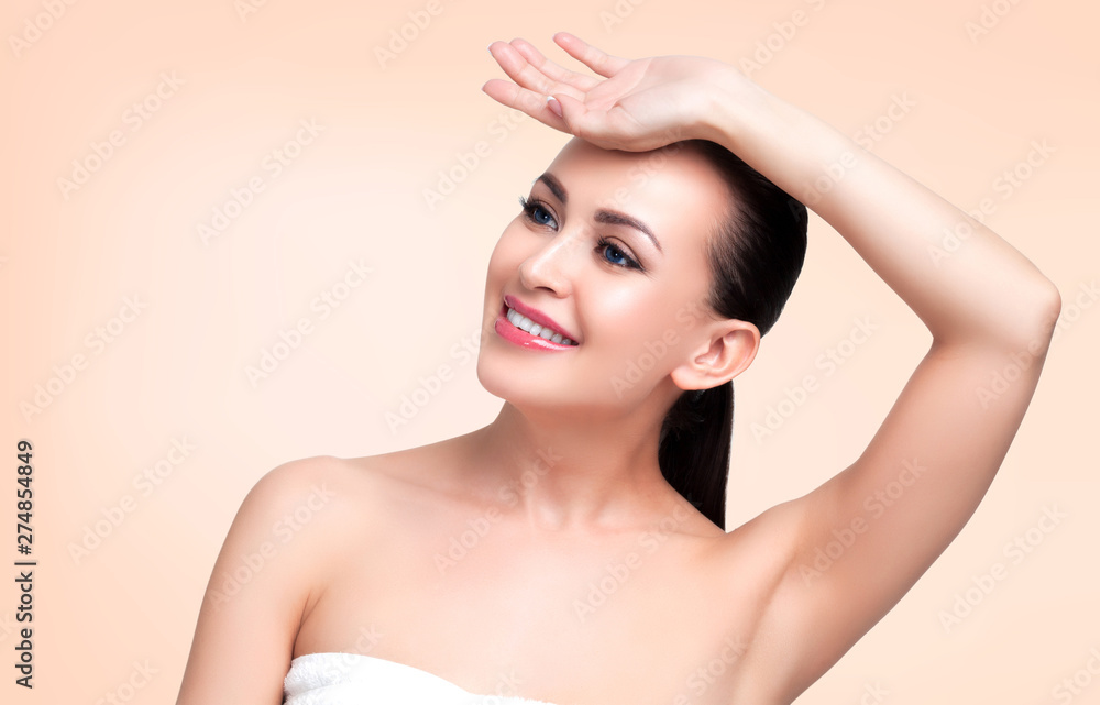 Beauty portrait of young woman in towel looking on something above. Skin care concept Beauty portrait of young woman in towel looking on something above. Skin care concept