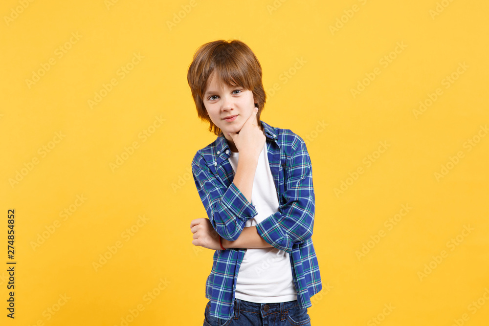 Fun cheerful happy little kid boy in blue shirt white t-shirt posing gesturing hands isolated on yellow wall background children studio portrait. People childhood lifestyle concept. Mock up copy space Fun cheerful happy little kid boy in blue shirt white t-shirt posing gesturing hands isolated on yellow wall background children studio portrait. People childhood lifestyle concept. Mock up copy space