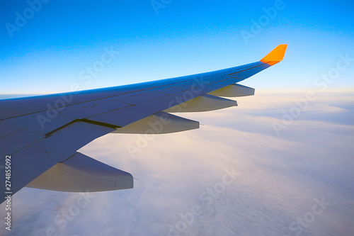wing airplane view of sky / blue sky and wing of an airplane, view from the cabin of an airplane, concept of air transport