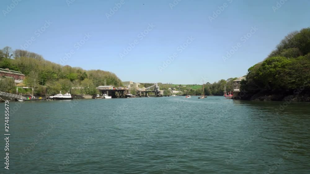 Crossing the river Fowey with views down the estuary showing the large ships and china clay industry docks. Cornwall, England, UK Crossing the river Fowey with views down the estuary showing the large ships and china clay industry docks. Cornwall, England, UK