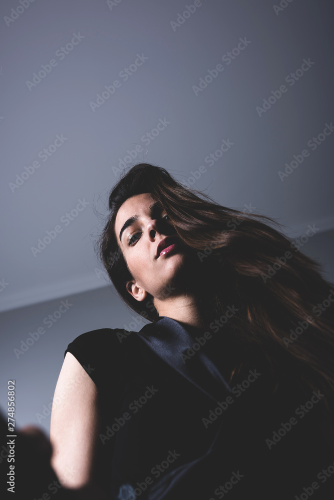 Low angle portrait of a beautiful serious woman