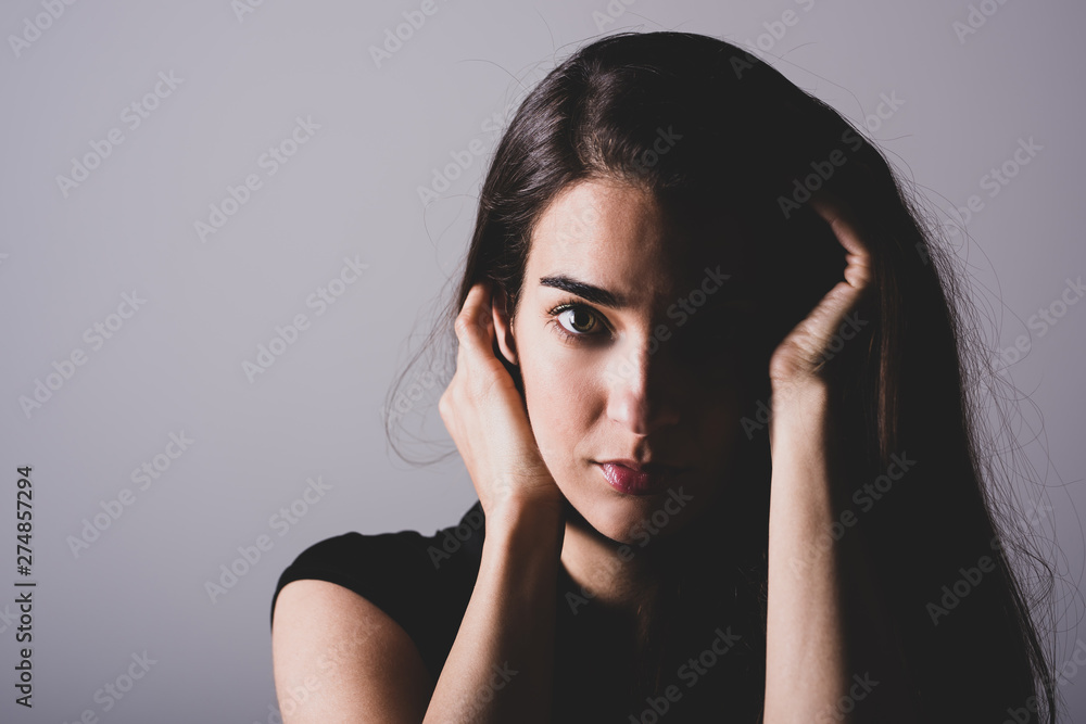 A serious young woman sitting on a sofa A serious young woman sitting on a sofa