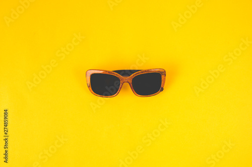 Women's sunglasses on yellow background