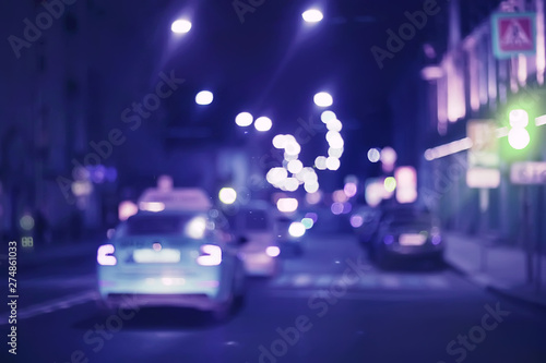 view of car in traffic jam / rear view of the landscape from window in car, road with cars, lights and the legs of the cars night view