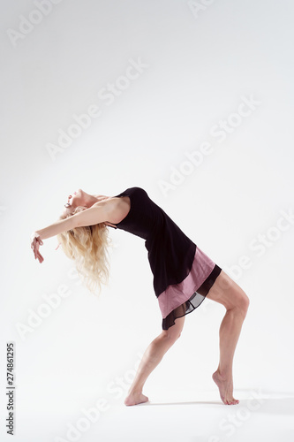 Image of young blonde dancing in empty studio on white background
