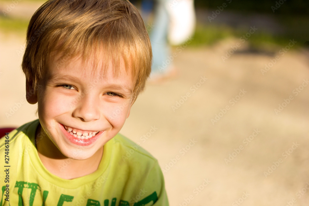 portrait of a boy with a smile close up, blurred background, warm toning, sunset light, place to insert text portrait of a boy with a smile close up, blurred background, warm toning, sunset light, place to insert text