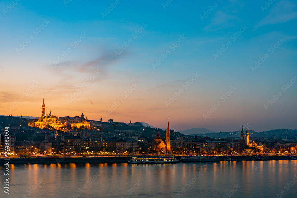 Night view of the Matthias Church and River Danube bank