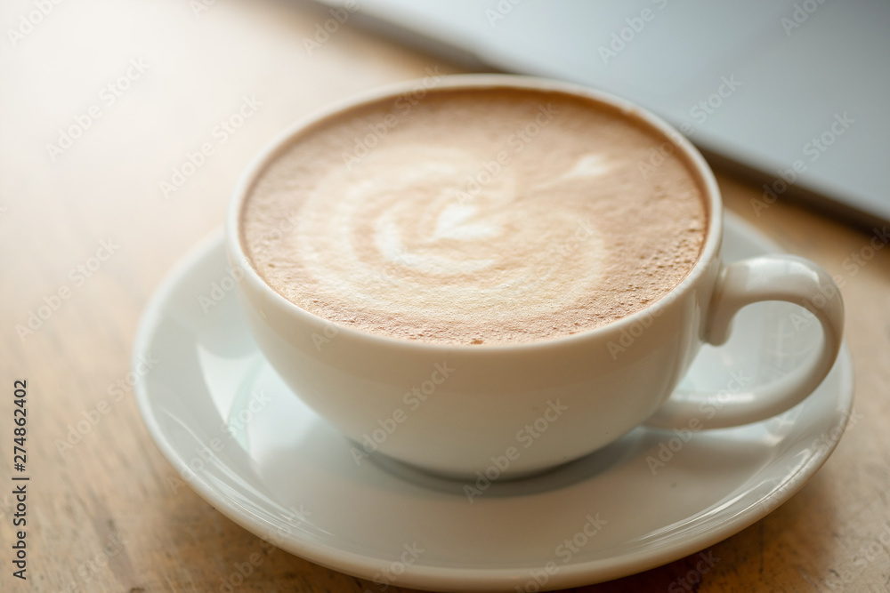 A cup of coffee on desk, Cup of coffee in hand, mug of latte coffee, Close up concept. A cup of coffee on desk, Cup of coffee in hand, mug of latte coffee, Close up concept.