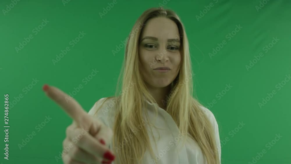 Portrait shot of young woman in augmented reality using virtual touchscreen, chroma key, green background Portrait shot of young woman in augmented reality using virtual touchscreen, chroma key, green background
