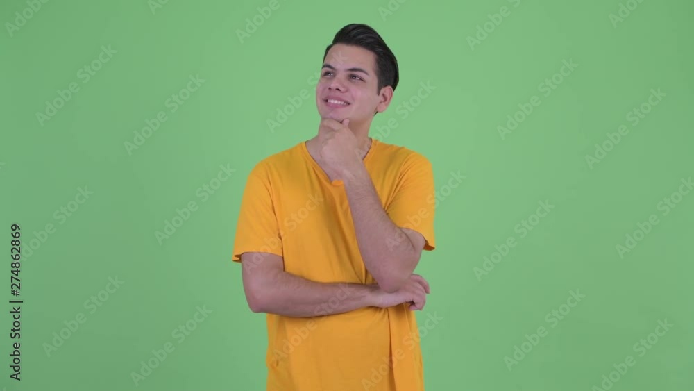 Happy young multi ethnic man thinking and looking up Happy young multi ethnic man thinking and looking up