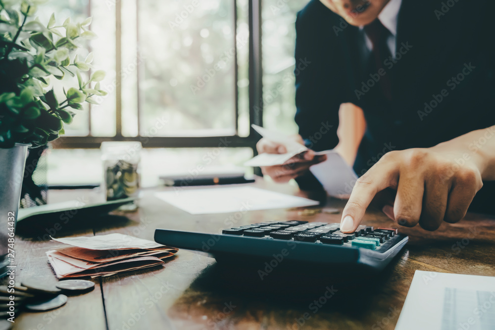 Fototapeta premium Accountant or banker calculate the cash bill.