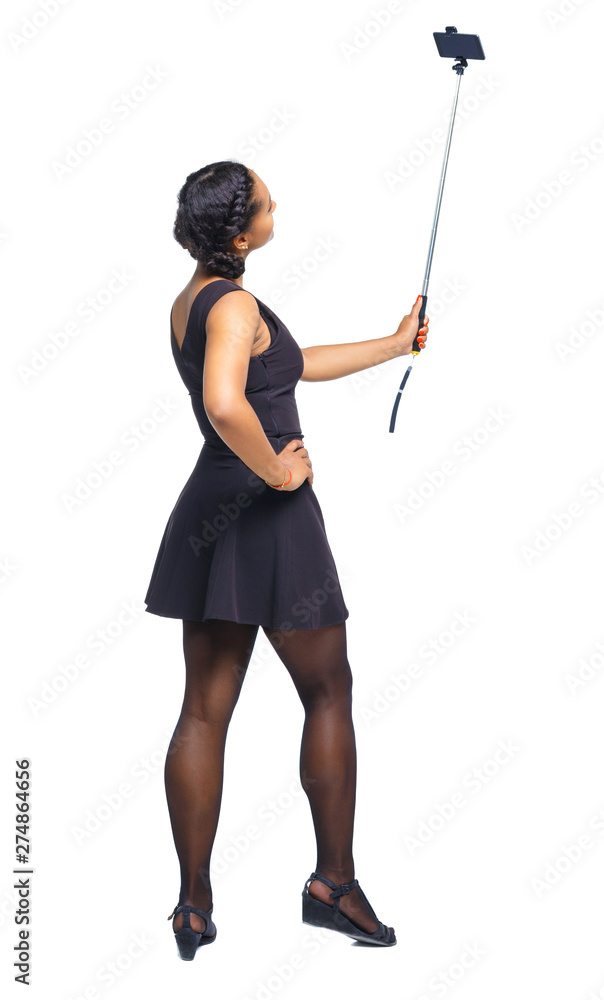 Back view of an African-American woman taking a selfie. Back view of an African-American woman taking a selfie.