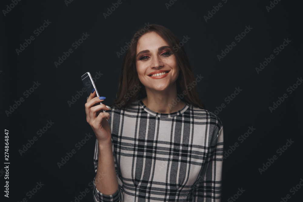 Obraz premium Sad teen being victim of cyber bullying online sitting on a couch in the living room at home