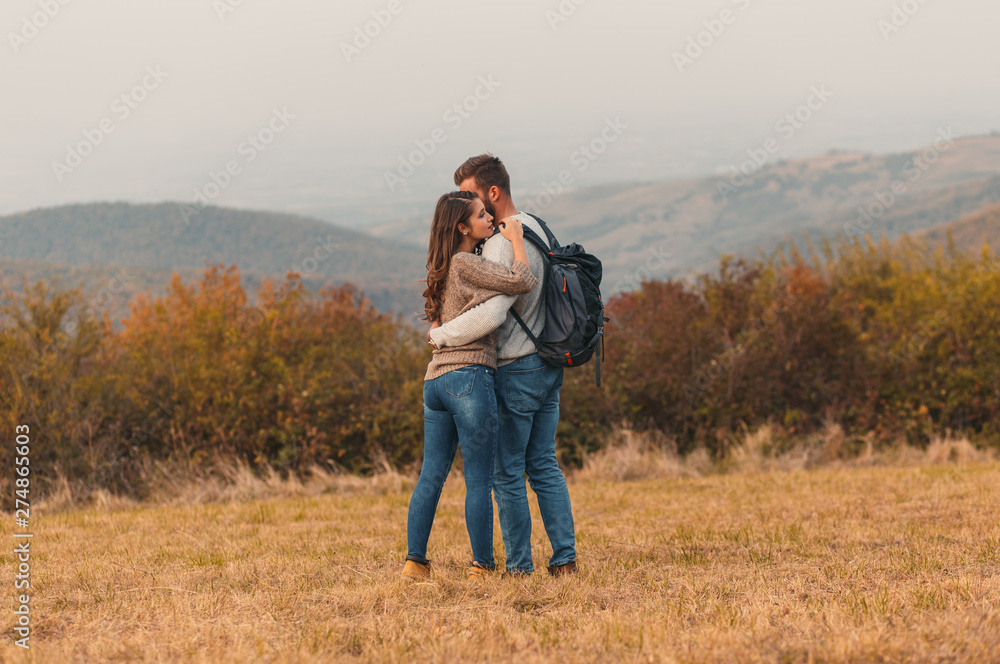 Young couple enjoying hiking together through the countryside. Young couple enjoying hiking together through the countryside.