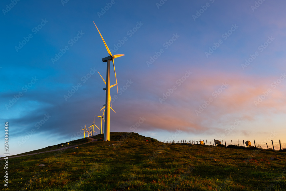 Wind turbines farm at sunrise, Oiz mountain, Basque Country, Spain Wind turbines farm at sunrise, Oiz mountain, Basque Country, Spain