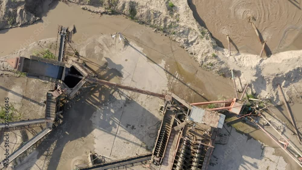 Top view of mining installation working on sand quarry. Sand mining industry. Top view of mining installation working on sand quarry. Sand mining industry.