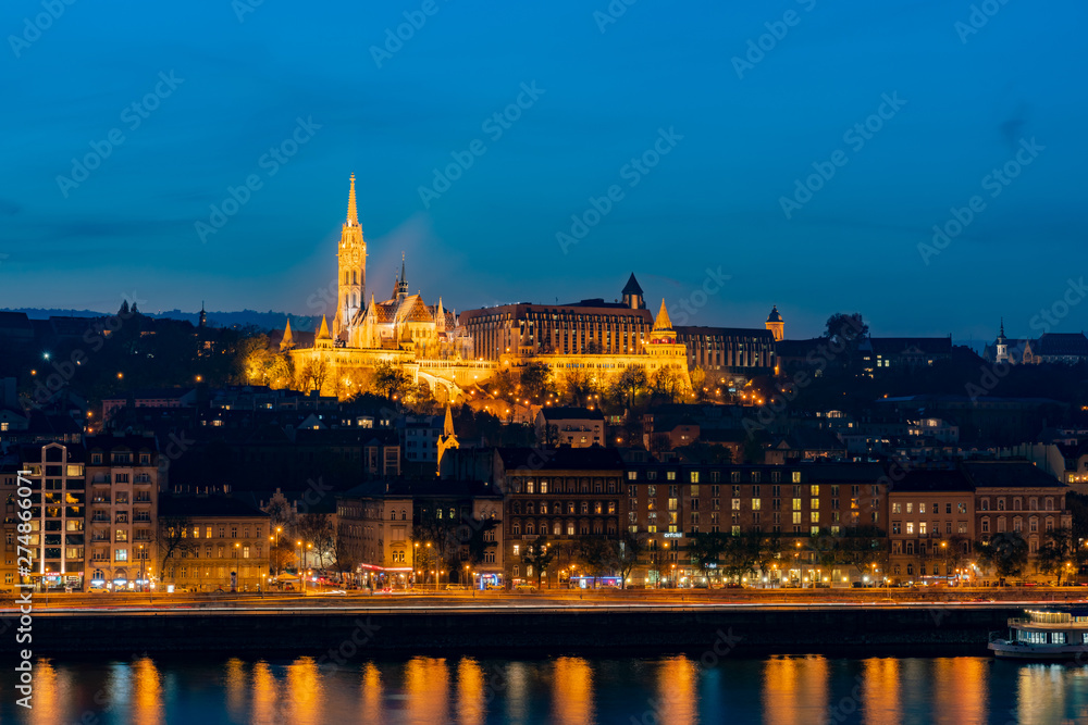 Night view of the Matthias Church and River Danube bank