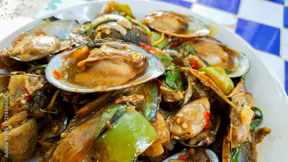 Spicy fried clam fried With eggplant and basil leaves, fresh and delicious red pepper, sea food, Thai food Spicy fried clam fried With eggplant and basil leaves, fresh and delicious red pepper, sea food, Thai food