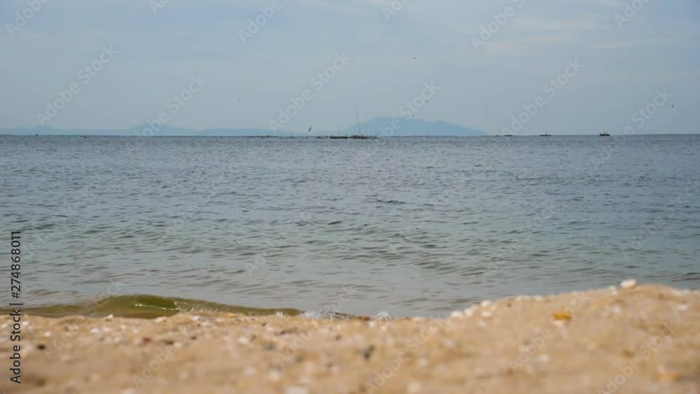 Tropical beach with white sand and blue sea in summer time on sunny day. Sea peaceful beach scenery foamy wave on the beach with waves of blue sea tropical ocean sand. travel vacation seaside. Tropical beach with white sand and blue sea in summer time on sunny day. Sea peaceful beach scenery foamy wave on the beach with waves of blue sea tropical ocean sand. travel vacation seaside.