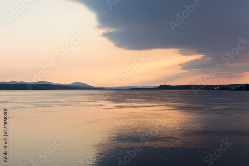 East view of the St. Lawrence River, with the Island of Orleans Bridge and Beauport Coast in the background at dawn, Quebec City, Quebec, Canada © Anne Richard