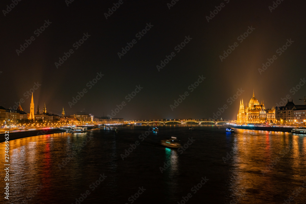 Night view of the Hungarian Parliament Building and River Danube bank