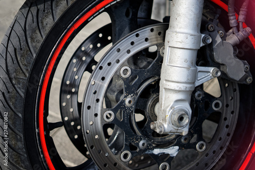 Front wheel and braking mechanism of a biker motorcycle. Road safety