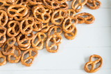 heap mini pretzel snacks with salt on white background