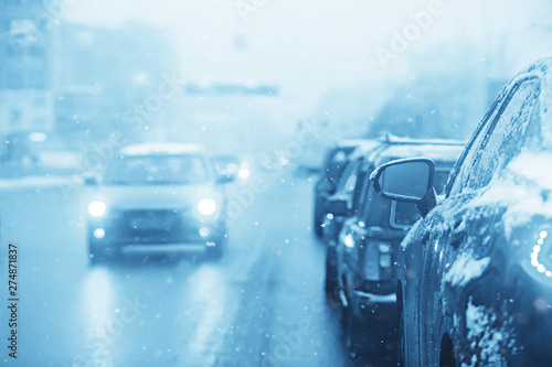 cars on winter road traffic jam city / winter weather on the city highway, the view from car in the fog and snow road