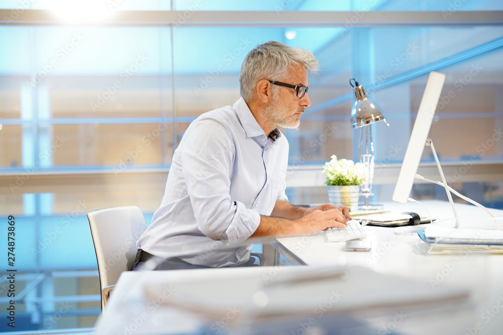 Smart casual businessman working in contemporary office Smart casual businessman working in contemporary office