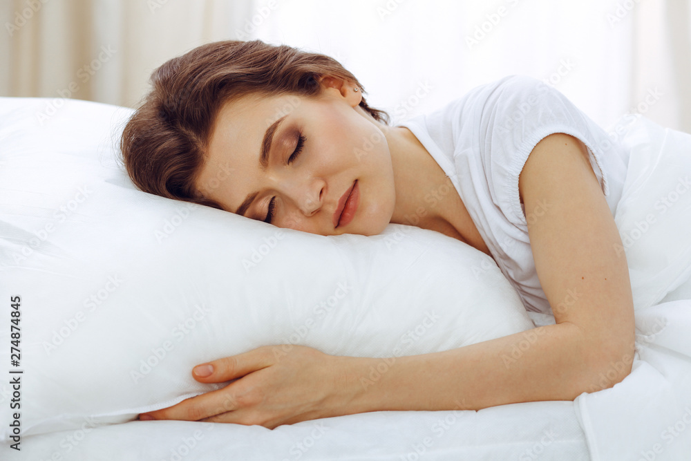 Beautiful young woman sleeping while lying in her bed. Concept of pleasant and rest reinstatement for active life Beautiful young woman sleeping while lying in her bed. Concept of pleasant and rest reinstatement for active life