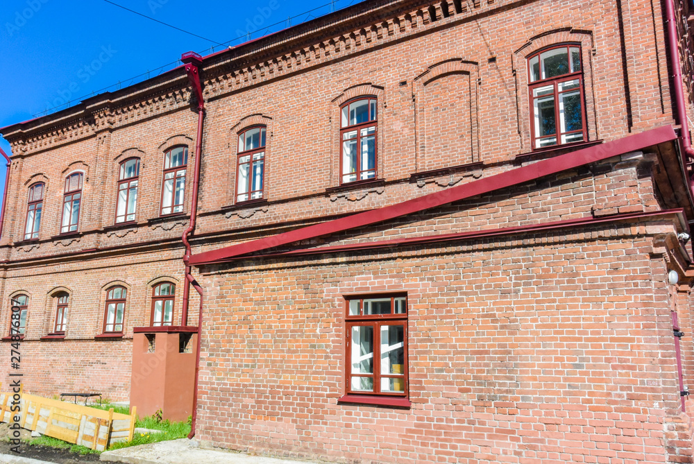 Fototapeta premium lesosibirsk / Russia - june 06 2019: old wooden houses with carved Windows. Small town. Village