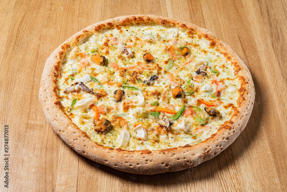 italian pizza on the wooden background italian pizza on the wooden background