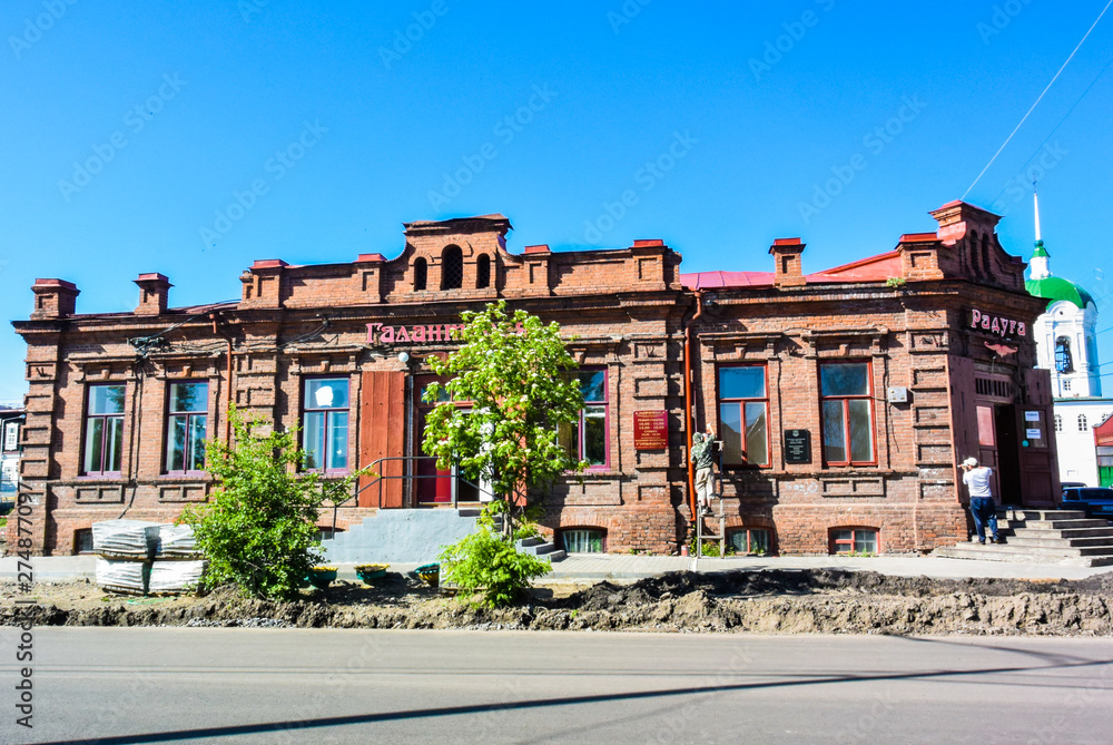 Fototapeta premium lesosibirsk / Russia - june 06 2019: old wooden houses with carved Windows. Small town. Village