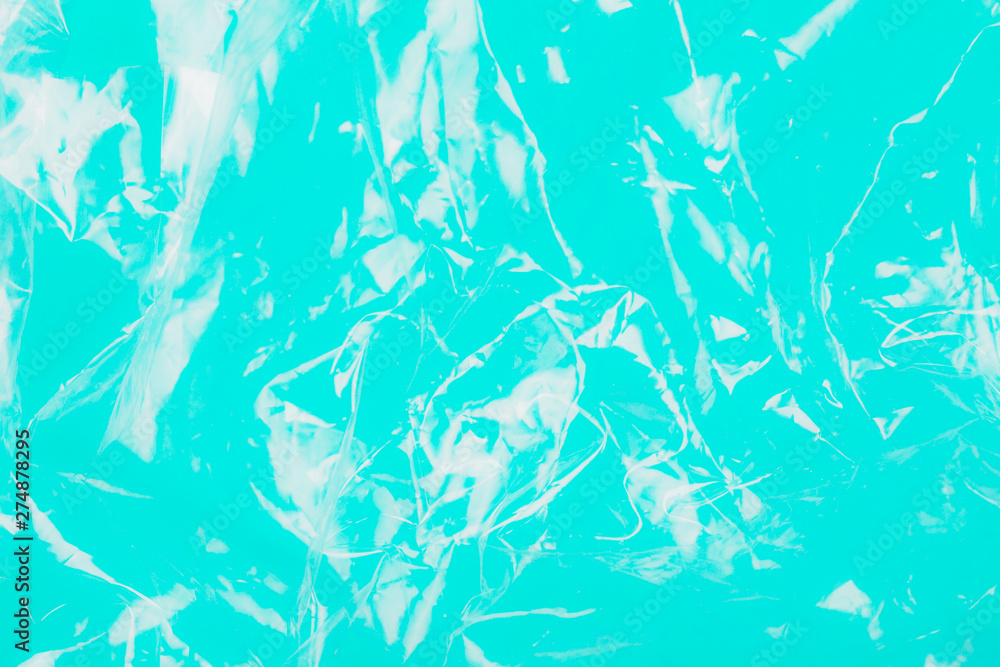 Abstract plastic texture on teal background as symbol of a major environmental problem. Ecology concept.