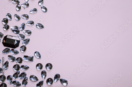 Fake jewelry stones on pink background. Jeweler concept