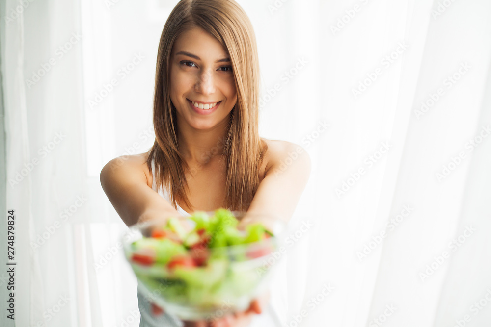 Diet and Healthy eating. Young woman eating healthy salad after workout