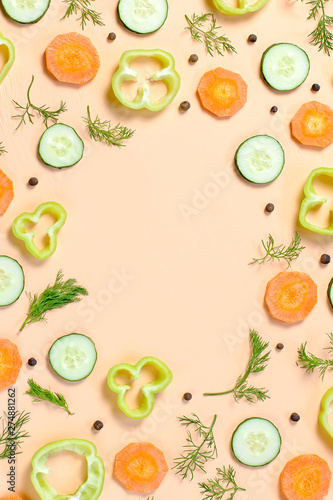 Fototapeta Naklejka Na Ścianę i Meble -  Salad ingredients layout. Food pattern with carrot, cucumbers, radish, greens, pepper and spices