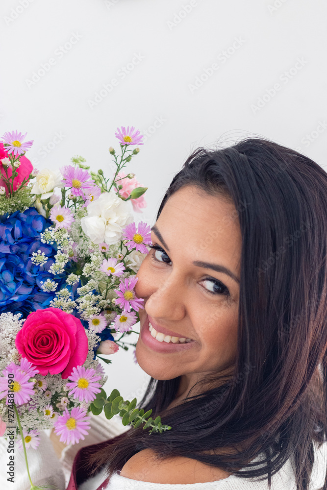 Cute brunette woman enjoying her bouquet of flowers Cute brunette woman enjoying her bouquet of flowers