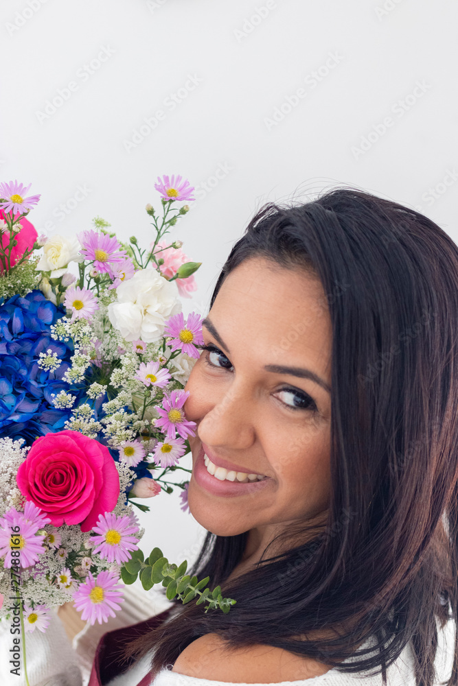 Cute brunette woman enjoying her bouquet of flowers Cute brunette woman enjoying her bouquet of flowers
