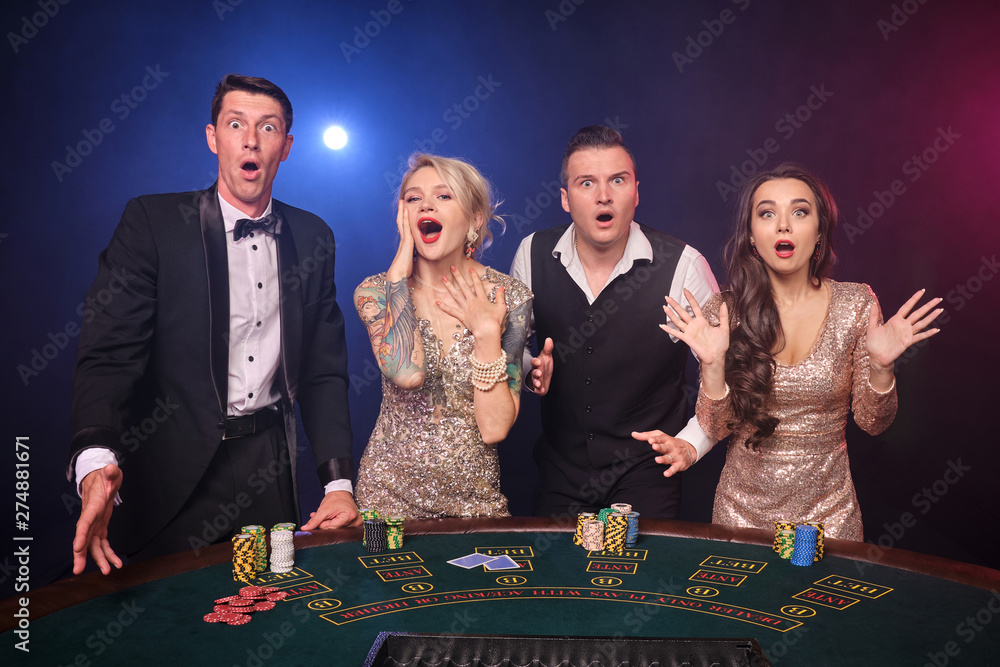 Group of a stylish rich friends are playing poker at casino. Group of a stylish rich friends are playing poker at casino.