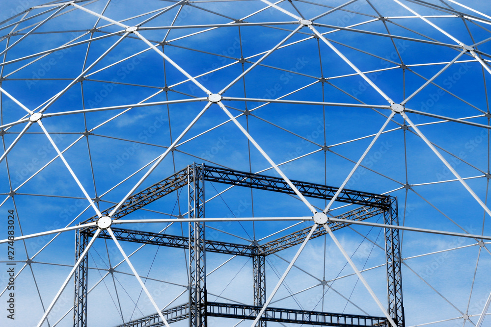 Fototapeta premium Sphere construction metal carcass and blue sky with white clouds.