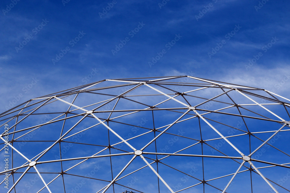 Fototapeta premium Metal constructions and blue sky with white clouds
