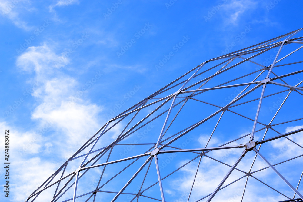 Fototapeta premium Metal constructions and blue sky with white clouds