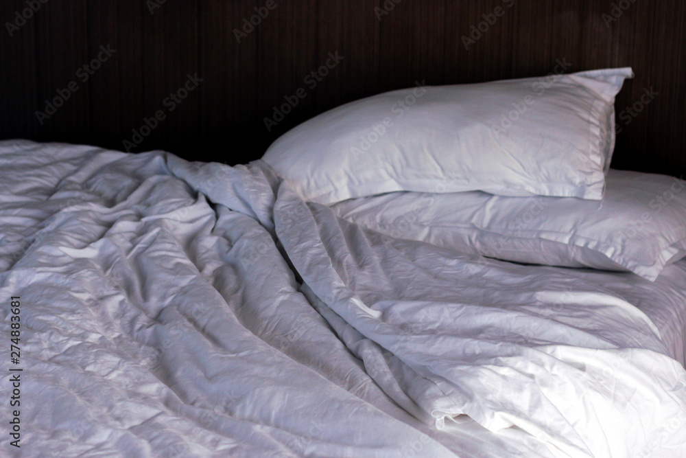 Fototapeta premium Messy bed. White pillow with blanket on bed unmade. 