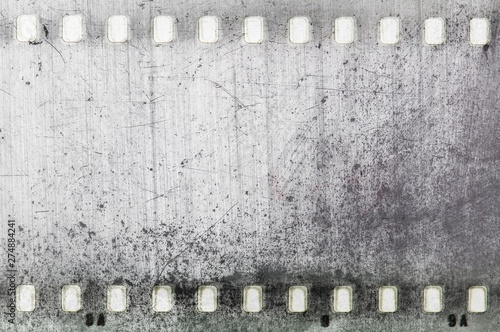 Vintage black and white film strip frame scratched textured.