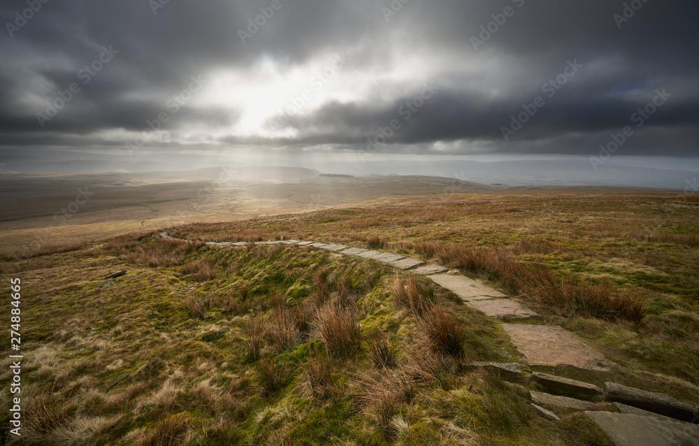 A stone path leading to the summit of Ingleborough, part of the Three Peaks in the Yorkshire Dales.
