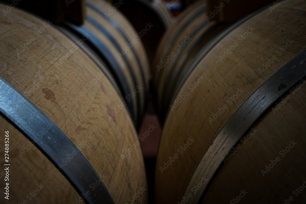 French oak wine barrel inside an italian wine cellar. top-back view. main colors: yellow; blue; silver;